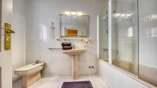 a bathroom with a sink and a shower and a toilet at Costacabana - Villa Miro in Lloret de Mar