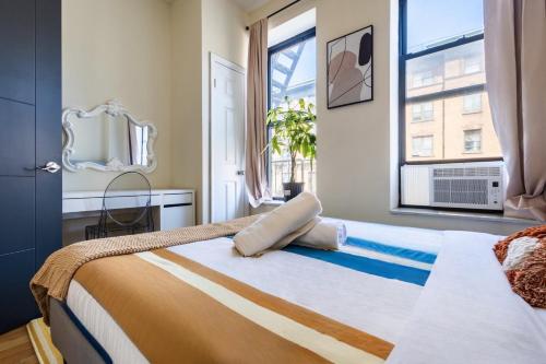 a bedroom with a large bed and a window at Gorgeous 4BD apt in the heart of NYC in New York