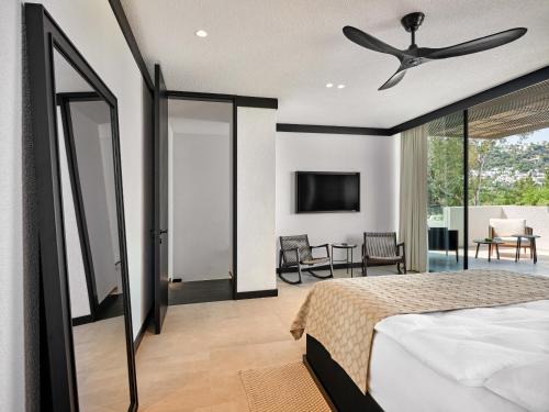a bedroom with a bed and a ceiling fan at Caja by Maxx Royal in Bodrum City