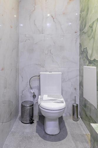a bathroom with a toilet and a trash can at Tinas Village Free Transport from/to the airport in Spáta
