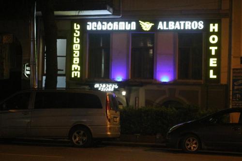 a van parked in front of a building at night at Hotel Albatros in Batumi