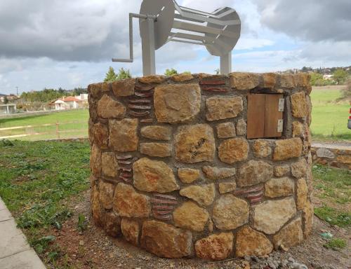 a stone wall with a light on top of it at EuZoea Country Home in Kapandrítion