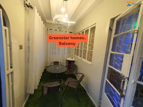 a room with a table and chairs in a hallway at Green home luxurious in Kisii
