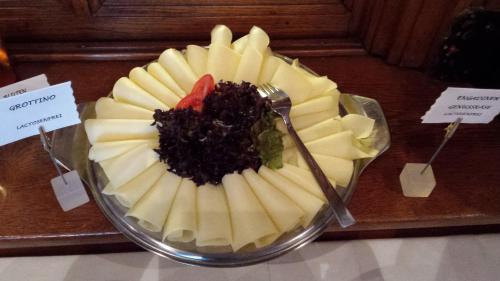 a fruit salad on a glass plate on a table at Hotel Terminus in Samedan