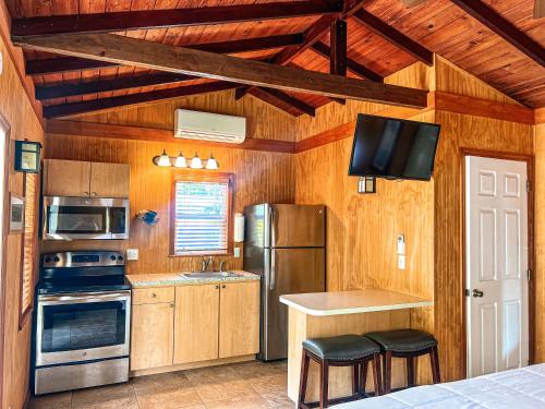 a kitchen with a refrigerator and a stove top oven at Sunset Cove Beach Resort in Key Largo