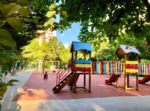 two colorful playground equipment in a park at Choice of Satisfaction in a Quality Neighborhood in Istanbul