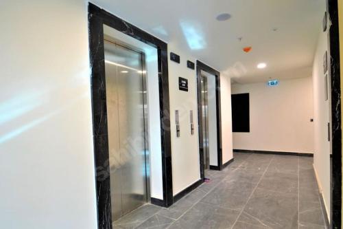 a hallway with four elevators in a building at Luxury Apartment in Istanbul