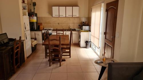 a kitchen with a table and chairs in it at Casa 6 pers. in Mendoza