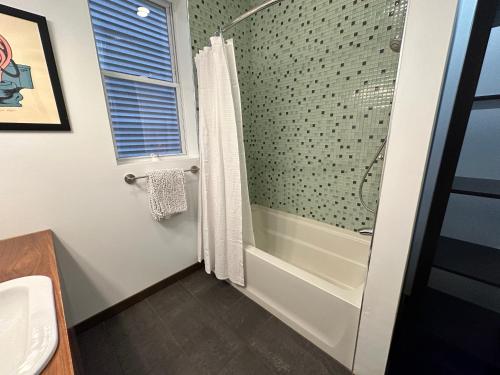 a bathroom with a shower and a sink at Logan Square Hideaway in Chicago