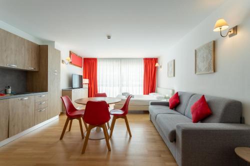 a living room with a couch and a table and chairs at Gressoney Saint-Jean apartments by Halldis in Gressoney-Saint-Jean