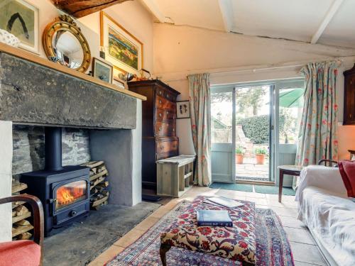 a living room with a fireplace and a couch at 1 Bed in Hay-on-Wye 81312 in Talgarth