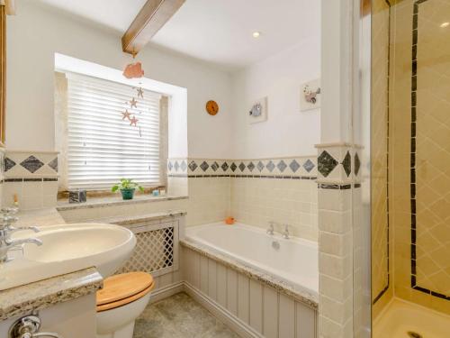 a bathroom with a tub and a sink and a toilet at 5 bed in Pateley Bridge 83663 in Summer Bridge