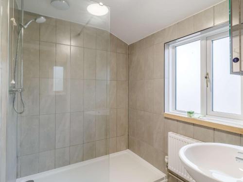 a bathroom with a shower and a sink at 3 Bed in Dunwich 85183 in Westleton