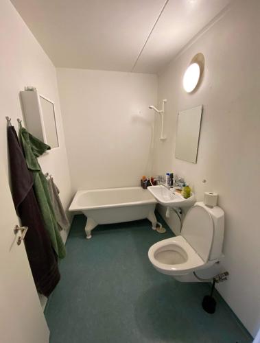 a bathroom with a toilet and a sink and a tub at lovely apartment in Gothenburg in Gothenburg