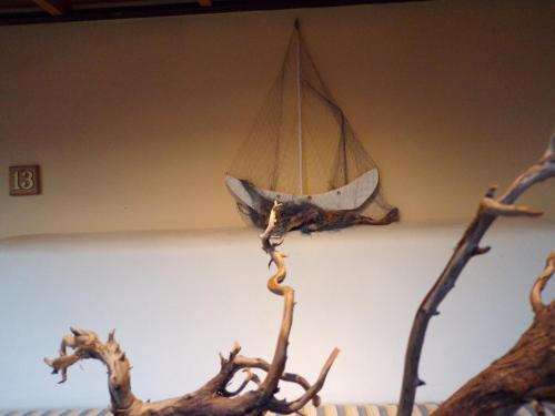 a model of a boat hanging from a ceiling at Le Due Sorelle in Spilia