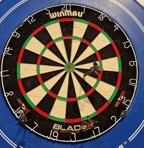 a close up of a dartboard with the wordulum at The Menai Hotel and Bar in Bangor