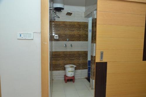 a bathroom with a shower with a toilet in it at Hotal Balaji in Gwalior