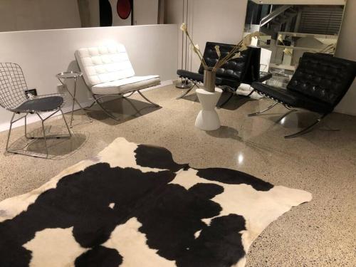 a room with chairs and a rug on the floor at WAREHOUSE! RARE!! NEW ARCHITECTURALLY DESIGNED MASTERPIECE!! BEST LOCAT! MASSIVE! PRIVATE ROOFTOP GARDEN w PANORAMIC CITY VIEWS!!! (B1-51-ImpAbb) in Sydney