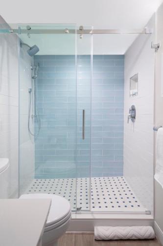 a bathroom with a glass shower with a toilet at Sanibel Island Beach Resort in Sanibel