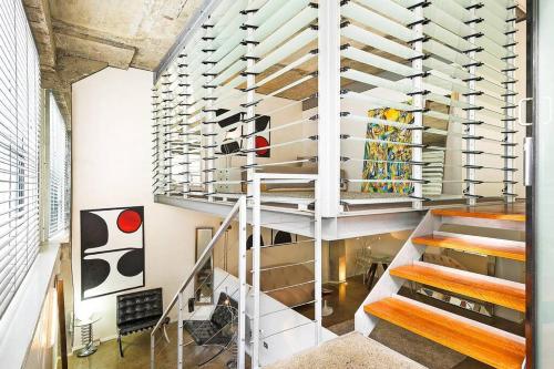 a room with a staircase with wine racks at WAREHOUSE! RARE!! NEW ARCHITECTURALLY DESIGNED MASTERPIECE!! BEST LOCAT! MASSIVE! PRIVATE ROOFTOP GARDEN w PANORAMIC CITY VIEWS!!! (B1-51-ImpAbb) in Sydney