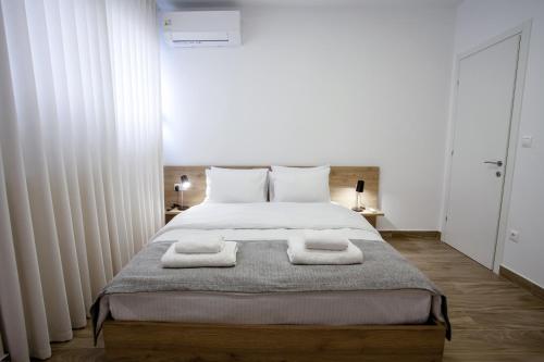 a bedroom with a bed with two towels on it at Airbnb Kastoria - Bella Vista B in Kastoria