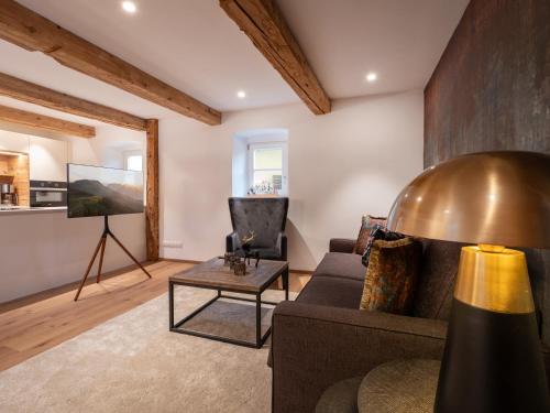 a living room with a couch and a table at Ferienwohnungen Egger in Hopfgarten im Brixental