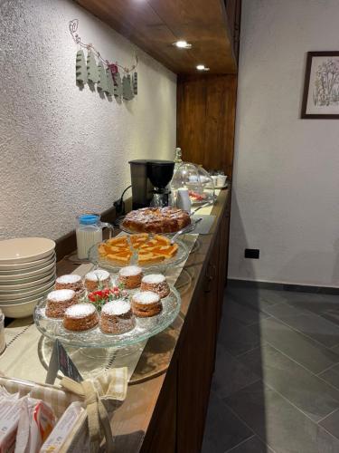 a buffet line with cakes and pastries on display at B&B Il Castellaccio - Albavilla in Albavilla