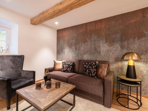 a living room with a couch and a table at Ferienwohnungen Egger in Hopfgarten im Brixental