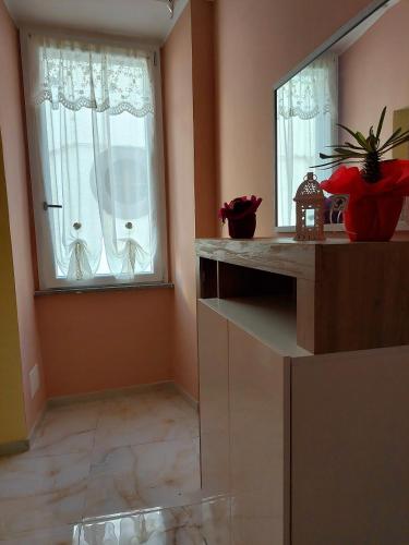 a living room with a mirror and a window at maison charlotte in Bagnaia