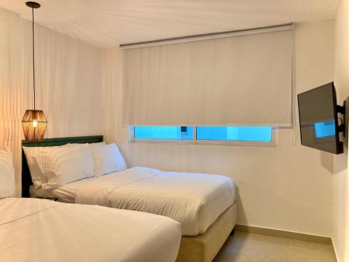 Postel nebo postele na pokoji v ubytování Bocagrande Comfort Stays