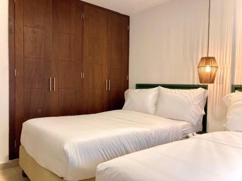 Postel nebo postele na pokoji v ubytování Bocagrande Comfort Stays