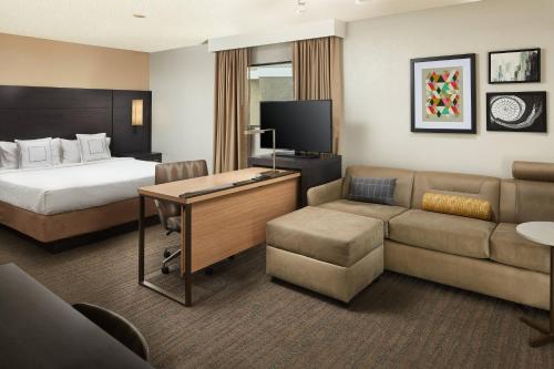 a hotel room with a bed and a desk and a couch at Residence Inn Irvine Spectrum in Irvine