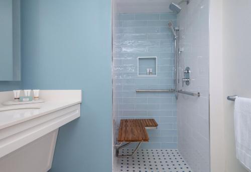 a bathroom with a shower with blue tiles at Sanibel Island Beach Resort in Sanibel