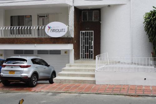 a silver car parked in front of a house at Absolute Hotel & Hostel Boutique in Medellín
