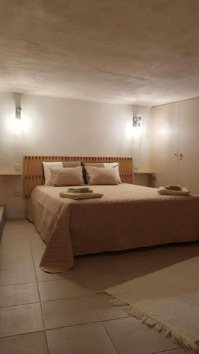 a bedroom with a large bed with two plates on it at Refúgio do Agricultor - Gerês in Montalegre