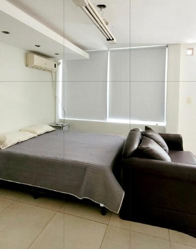 a bedroom with a bed and a glass wall at -AMBIENTE BOTIQUE- Tu lugar ideal- in Santiago del Estero