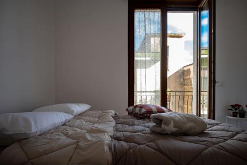 a large bed in a room with a large window at Classy House in Marigliano in Marigliano