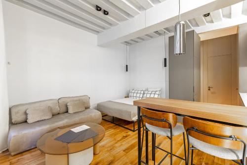 un salon avec un canapé et une table dans l'établissement La Suite Parisienne, à Paris