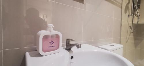 a soap bottle sitting on top of a sink in a bathroom at TREASURE HUNTER At Heritage Georgetown in George Town