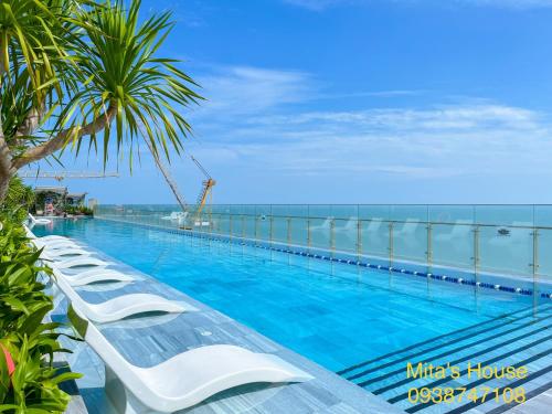 a swimming pool with a view of the ocean at Mita's House - The Sóng Apartment Vũng Tàu in Vung Tau