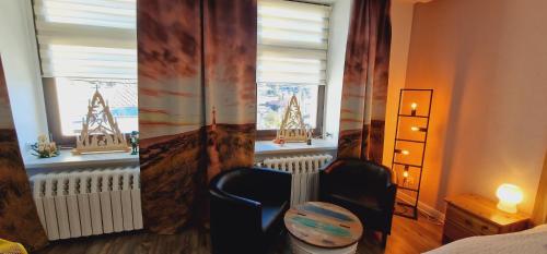 a bedroom with a chair in front of a window at Großzügige Fewo Peter in Bärenstein in Bärenstein