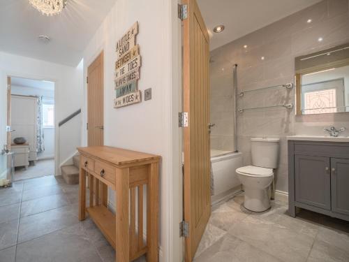 a bathroom with a toilet and a sink and a shower at 2 Bed in Tywyn DY052 in Tywyn