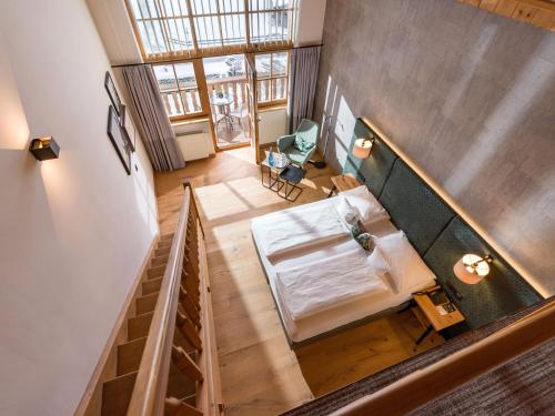 an overhead view of a room with a bed and a table at Hotel & Spa Sonne 4 Sterne Superior in Kirchberg in Tirol