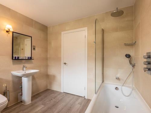 a bathroom with a shower and a sink and a toilet at 3 Bed in St. Mellion 87718 in St Mellion