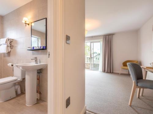 a bathroom with a sink and a mirror at 3 Bed in St. Mellion 87719 in St Mellion