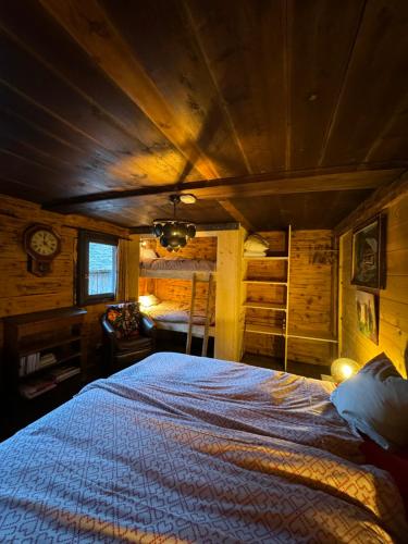 a bedroom with a large bed in a cabin at Warm and Stylish Boutique Lodge L'Etoile de Savoie in Abondance