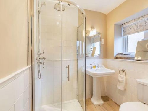 a bathroom with a glass shower and a sink at Juliet Cottage, late Georgian treasure, charming, cosy and historic, only a short walk to Alnwick Castle in Alnwick