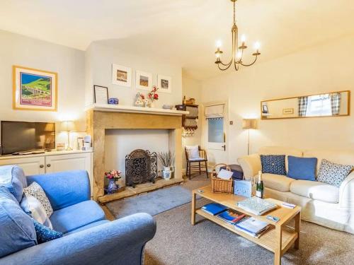 a living room with two couches and a fireplace at Juliet Cottage, late Georgian treasure, charming, cosy and historic, only a short walk to Alnwick Castle in Alnwick