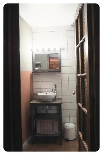 a bathroom with a sink and a mirror at la Ferme de Vazerat in Massiac