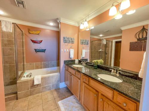 a bathroom with two sinks and a shower at 411 Holiday Isle 411 in Dauphin Island